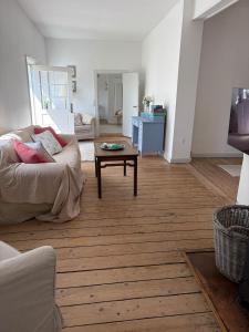 a living room with a couch and a coffee table at The South Wing at Højbygård in Rødby