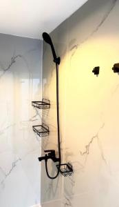 a bathroom with a shower with marble walls at سكون in Al Baha