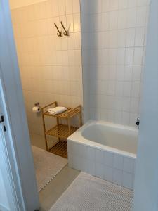 a bathroom with a white tub and a table at The South Wing at Højbygård in Rødby +24 photos