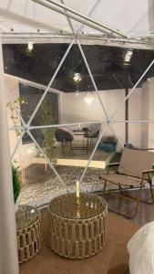 a room with two round tables with a candle at سكون in Al Baha