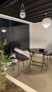 a patio with a table and two chairs and a table at سكون in Al Baha