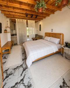 a bedroom with a large bed and a wooden ceiling at Bedro Rooftop Studio 2 Private Balcony Sea View 30 Sec to Sea in Dahab