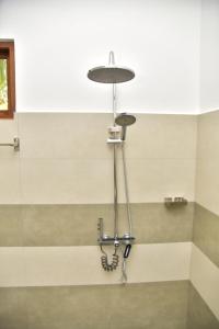 a light hanging from the ceiling in a bathroom at Buddika Safari & Resort in Udawalawe