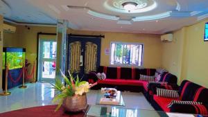 a living room with a couch and a table at Hotel Omnisport in Limbe