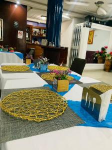 a group of tables in a room with flowers on them at Hotel Omnisport in Limbe