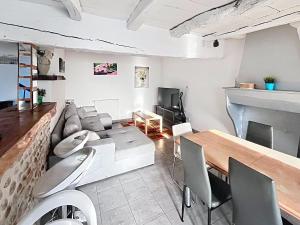 a living room with a couch and a table at La Grande Chaumiere in Saint-Vulbas