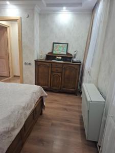 a bedroom with a bed and a dresser in it at Eka's house in Kazbegi Goristsikhe in Itʼkhvisi +7 photos