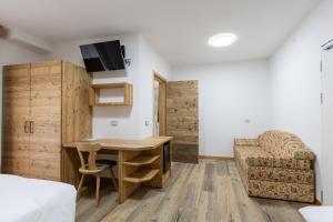 a living room with a desk and a couch at Hotel Venezia in Rocca Pietore