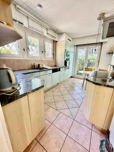 a large kitchen with a large tile floor at Villa Lake View in Grandvaux