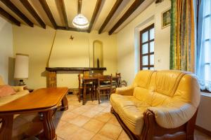 a living room with a couch and a table at On The Rocks - Alpes Mancelles - Jardin in Sillé-le-Guillaume