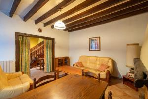 a living room with a couch and a table at On The Rocks - Alpes Mancelles - Jardin in Sillé-le-Guillaume