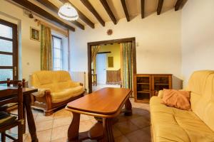 a living room with a couch and a table at On The Rocks - Alpes Mancelles - Jardin in Sillé-le-Guillaume +17 photos