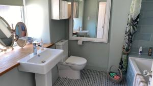 a bathroom with a sink and a toilet and a mirror at Market House 17th Century Boutique B&B in Wincanton +26 photos