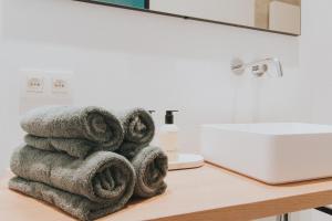 a pile of towels sitting on a counter next to a sink at Paulus41 in Antwerp
