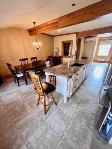 a kitchen and dining room with a table and chairs at La Tournesol in Granby