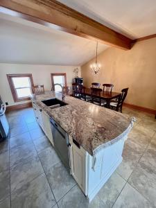 a kitchen with a counter top and a dining room at La Tournesol in Granby