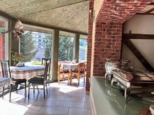 a living room with a table and a stove at Gościniec Saba in Zieleniec