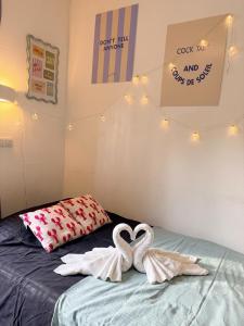 two swan towels on a bed in a bedroom at Côté green in Juvignac +13 photos