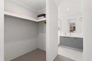 a white bathroom with a sink and a mirror at Drift at Shorehaven Coast in Alkimos +37 photos
