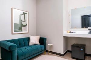 a living room with a blue couch and a sink at The Oliver Hotel - Adults Only in San Juan +52 photos