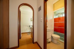 a bathroom with a toilet and a mirror at Travessa in Lisbon +16 photos
