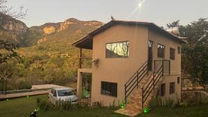 a house with a car parked in front of it at Chale2RabodeGalo in Santana do Riacho +26 photos