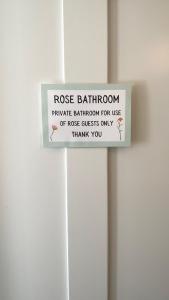 a sign on a door that readsrosis bathroom private bathroom for use ofrosis guests at Market House 17th Century Boutique B&B in Wincanton