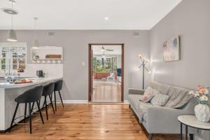 a living room with a couch and a kitchen at The Retreat, Barossa Valley in Lights Pass