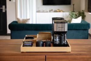a coffeemaker on a wooden tray on a table at The Oliver Hotel - Adults Only in San Juan
