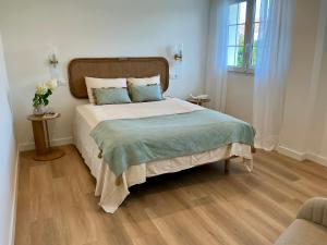 a bedroom with a large bed and a window at Quinta del Mar suites - Costa Quebrada in Soto de la Marina