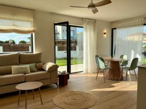 a living room with a couch and a table at Quinta del Mar suites - Costa Quebrada in Soto de la Marina