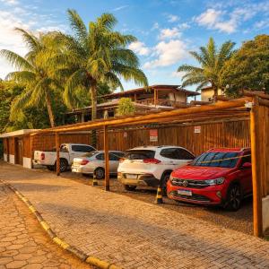a row of cars parked in a parking lot at Residência Thomas in Itacaré