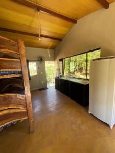 a room with a bunk bed and a refrigerator at Chale3 Rabodegalo in Santana do Riacho +41 photos
