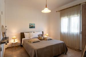 a bedroom with a bed with two pillows on it at Sunset Luxury Potidea in Metókhion Patriotikón