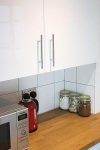 a kitchen with a counter with a toaster and jars at West Hill Apartment in Brighton & Hove