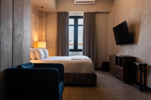 a hotel room with a bed and a television at The Oliver Hotel - Adults Only in San Juan