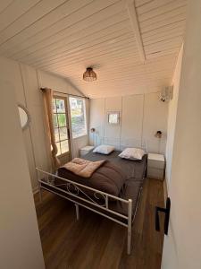 a bedroom with a bed in a small room at Camping le Cabri in Duras