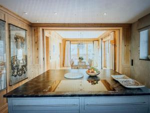 a kitchen with a table with a bowl of fruit on it at Valley View Residence in Sankt Anton am Arlberg