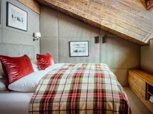 a bedroom with a bed with red pillows on it at Valley View Residence in Sankt Anton am Arlberg