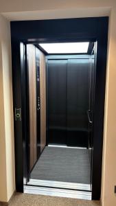 a glass door of a elevator in a building at Pension Hauenstein in Lagundo