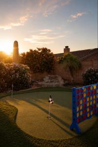 a miniature golf course in the yard of a house at Desert Disconnect Pool and Putting Green in Gilbert