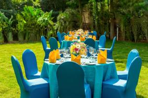 a table set up for a party with blue tables and chairs at Hotel Gwalior Regency, a member of Radisson Individuals in Gwalior