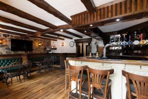 a bar with chairs and a counter in a room at The Tavern in Buchlyvie