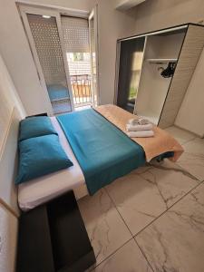 a bed in a room with a large window at XXL APARTMENTS CiTY CENTAR 1 in Bitola
