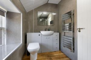 a bathroom with a white toilet and a sink at The Tavern in Buchlyvie +74 photos