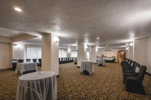 a banquet hall with two tables and chairs and tablesearcher at Gamma Merida El Castellano in Mérida +18 photos