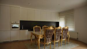 a dining room with a table and chairs at Lux Stays in Prishtinë
