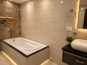 a bathroom with a bath tub and a sink at Castal Blue Hotel Near IGI Delhi Airport - Free Breakfast and Dinner complementry in New Delhi