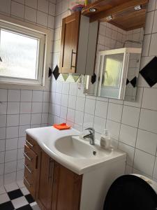 a bathroom with a sink and a mirror at Vila in Hultsfred +71 photos