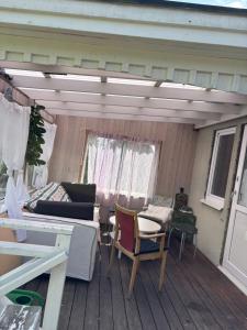 a patio with a couch and chairs on a deck at Vila in Hultsfred